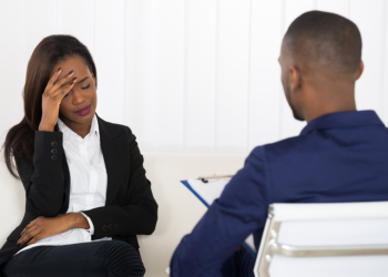 Depressed African American Woman At Psychiatrist Appointment